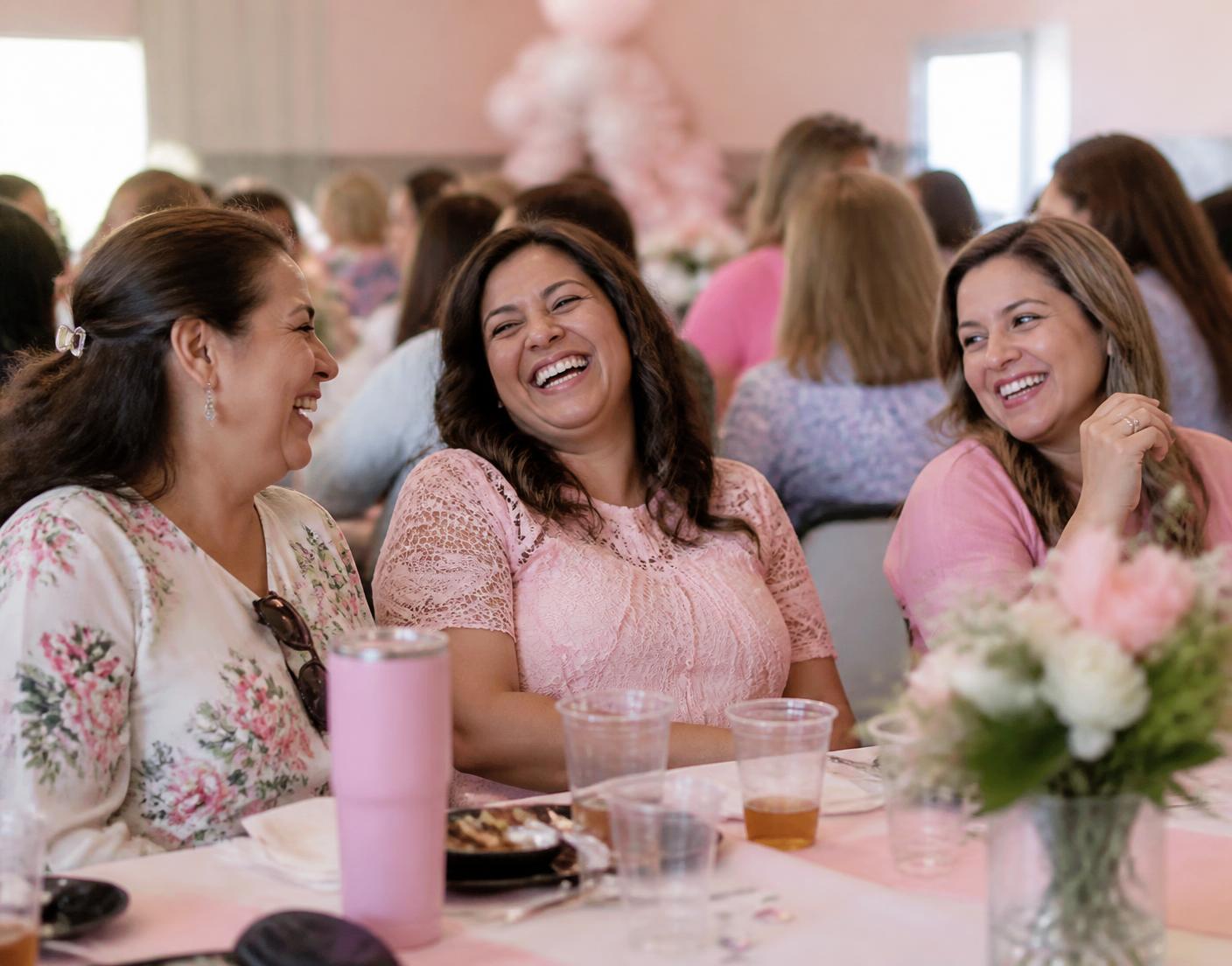 Women laughing together at a Rise Haven community gathering
